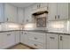 Kitchen with white cabinetry, granite counters, decorative backsplash, and stainless steel appliances at 1089 Virginia St, Dunedin, FL 34698