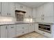 Custom kitchen with a stylish tile backsplash, stainless steel appliances, and plenty of cabinet space at 1089 Virginia St, Dunedin, FL 34698