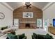 Elegant living room showcasing a brick fireplace, vaulted ceilings, and modern accents at 1089 Virginia St, Dunedin, FL 34698