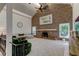 Spacious living room featuring a brick fireplace, vaulted ceilings, and elegant decor at 1089 Virginia St, Dunedin, FL 34698