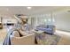Inviting living room with neutral tones, decorative rug, and a striking staircase at 1089 Virginia St, Dunedin, FL 34698