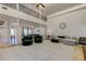 Bright living room featuring a high ceiling, a large window, and an open floor plan at 1089 Virginia St, Dunedin, FL 34698