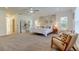 Bright main bedroom featuring a decorative headboard wall, carpet flooring, and elegant seating at 1089 Virginia St, Dunedin, FL 34698