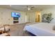 Bright main bedroom features a TV, decorative wall niches, and seating area at 1089 Virginia St, Dunedin, FL 34698