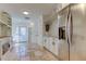 Bright mud room with custom built-ins, tile floors, and stainless steel appliances near the front door at 1089 Virginia St, Dunedin, FL 34698