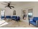 Relaxing covered patio features tile floors, fan and comfortable seating, great for outdoor living and entertaining at 1089 Virginia St, Dunedin, FL 34698