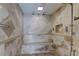 Luxurious shower with dual shower heads, a built-in seat, and stylish tile work at 1089 Virginia St, Dunedin, FL 34698