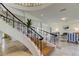 Close-up of the spiral staircase, hardwood steps, and wrought iron railing detail at 1089 Virginia St, Dunedin, FL 34698