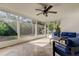 Bright sunroom with comfortable seating and views of the landscaped backyard at 1089 Virginia St, Dunedin, FL 34698