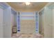 Well-organized walk-in closet with custom shelving, drawers, and ample hanging space for clothes at 1089 Virginia St, Dunedin, FL 34698
