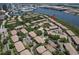 Aerial view of a residential community with a swimming pool, tennis courts, and waterfront views at 1111 Normandy Trace Rd # 1111, Tampa, FL 33602