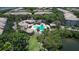 Aerial view of a community pool, lush landscaping, and waterfront access surrounded by trees at 1111 Normandy Trace Rd # 1111, Tampa, FL 33602