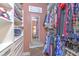 Well-organized walk-in closet with shelving, drawers, hanging clothes, and a mirror at 1111 Normandy Trace Rd # 1111, Tampa, FL 33602