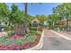Beautiful entrance to Island Place Island Walk, featuring manicured landscaping and a charming guard house at 1111 Normandy Trace Rd # 1111, Tampa, FL 33602