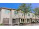 Charming townhome featuring attached garages, neutral stucco, and well-manicured landscaping at 1111 Normandy Trace Rd # 1111, Tampa, FL 33602
