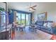 Bright living room featuring a leather couch, ceiling fan, large window, and stylish furniture arrangement at 1111 Normandy Trace Rd # 1111, Tampa, FL 33602