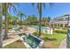 Beautiful community pool area featuring a water feature, tropical landscaping, and plenty of lounge chairs at 1111 Normandy Trace Rd # 1111, Tampa, FL 33602