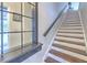 Clean and bright staircase with hardwood treads and white risers, complemented by a dark handrail at 1111 Normandy Trace Rd # 1111, Tampa, FL 33602