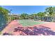 Well-maintained tennis court surrounded by lush greenery and under a clear blue sky at 1111 Normandy Trace Rd # 1111, Tampa, FL 33602