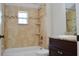 Bathtub with shower and shelving unit in a naturally lit bathroom at 11141 Rex Hunter Ln, Lithia, FL 33547