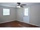 Bedroom with fan, window, door to back yard and wood flooring at 11141 Rex Hunter Ln, Lithia, FL 33547