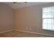 This bedroom has neutral walls and carpeting with a large window at 11141 Rex Hunter Ln, Lithia, FL 33547