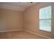 This bedroom has neutral walls and carpeting with a large window at 11141 Rex Hunter Ln, Lithia, FL 33547