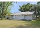 Single-story home featuring a metal roof and back porch at 11141 Rex Hunter Ln, Lithia, FL 33547