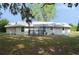 Charming single-story home featuring a metal roof and front porch at 11141 Rex Hunter Ln, Lithia, FL 33547