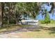 Exterior view of home with mature trees at 11141 Rex Hunter Ln, Lithia, FL 33547