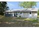 The home features neutral siding, a metal roof, and a small front porch at 11141 Rex Hunter Ln, Lithia, FL 33547