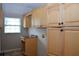 Convenient laundry room equipped with ample storage space and a countertop at 11141 Rex Hunter Ln, Lithia, FL 33547