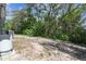 Spacious backyard with mature trees providing privacy and shade and room to relax at 11409 Spring Hill Dr, Spring Hill, FL 34609