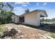 Exterior shot showcasing the home's siding, porch, and the natural landscape surrounding the property at 11409 Spring Hill Dr, Spring Hill, FL 34609
