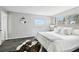 Bright bedroom with wood-look floors, natural light, and stylish decor at 11409 Spring Hill Dr, Spring Hill, FL 34609