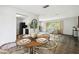 Open-concept dining area flowing into the living room, featuring a wooden table with seating for four at 11409 Spring Hill Dr, Spring Hill, FL 34609