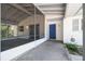 The screened porch of the house highlights the entryway with its welcoming blue door at 11409 Spring Hill Dr, Spring Hill, FL 34609