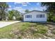 Simple and efficient home design showcasing functional features and pleasant yard at 11409 Spring Hill Dr, Spring Hill, FL 34609