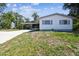A well-kept home with carport, screened porch, side lawn and simple landscaping at 11409 Spring Hill Dr, Spring Hill, FL 34609