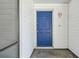 Charming blue front door with six panels set against white siding, welcoming guests to the property at 11409 Spring Hill Dr, Spring Hill, FL 34609