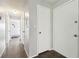 Hallway with neutral walls and a series of white doors, offering access to other areas of the home at 11409 Spring Hill Dr, Spring Hill, FL 34609