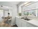 Kitchen features a double basin with window view of screened-in porch and dining area at 11409 Spring Hill Dr, Spring Hill, FL 34609