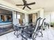 Balcony with tiled flooring, four chairs with cushions and a ceiling fan for comfortable seating at 120 1St E St # 104, St Petersburg, FL 33715