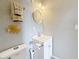 Compact bathroom featuring a white vanity, nautical decor, and neutral paint at 120 1St E St # 104, St Petersburg, FL 33715