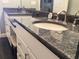 Bathroom with gray granite counters, double sink, and vanity at 120 1St E St # 104, St Petersburg, FL 33715