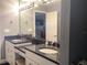Bathroom with double vanity and a large mirror, offering a bright and spacious atmosphere at 120 1St E St # 104, St Petersburg, FL 33715