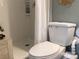 Bathroom features a white toilet and shower with a white shower curtain at 120 1St E St # 104, St Petersburg, FL 33715