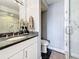 Contemporary bathroom vanity with granite countertop and walk-in shower with marble tile surround at 120 1St E St # 104, St Petersburg, FL 33715