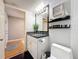 Contemporary bathroom with vanity, granite countertop, toilet, decor shelf, modern fixtures and accessories at 120 1St E St # 104, St Petersburg, FL 33715