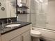 Bathroom featuring a granite countertop vanity and glass enclosed shower at 120 1St E St # 104, St Petersburg, FL 33715